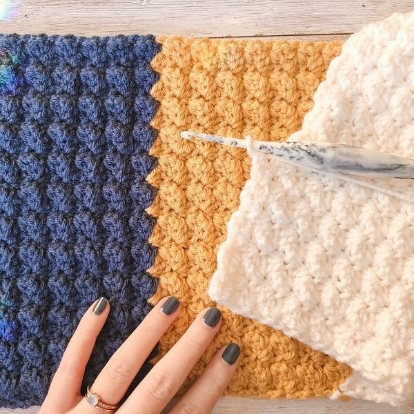 two crocheted squares are shown with one being used as a ring holder and the other is made out of yarn