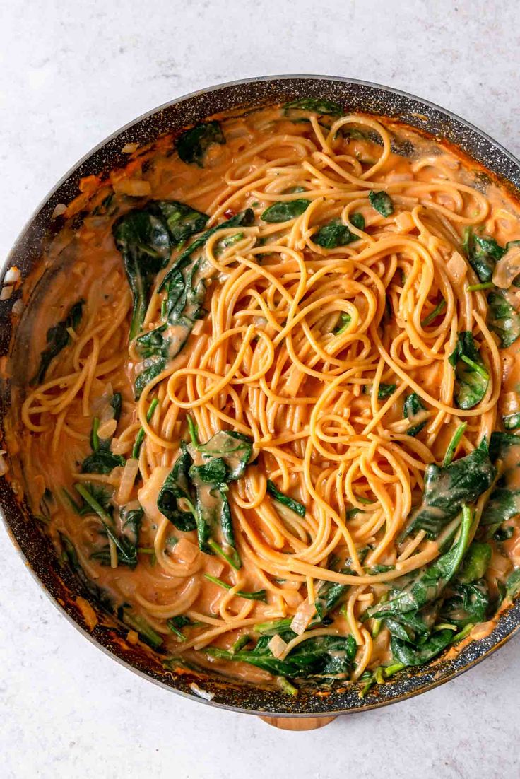 a pan filled with pasta and spinach