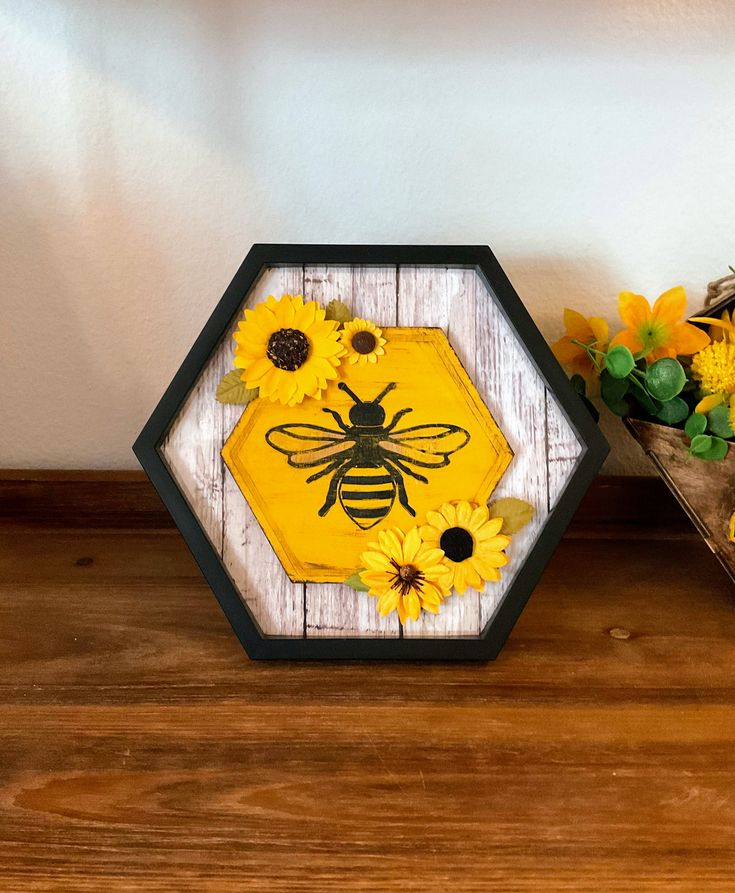 two vases with sunflowers and a bee on them