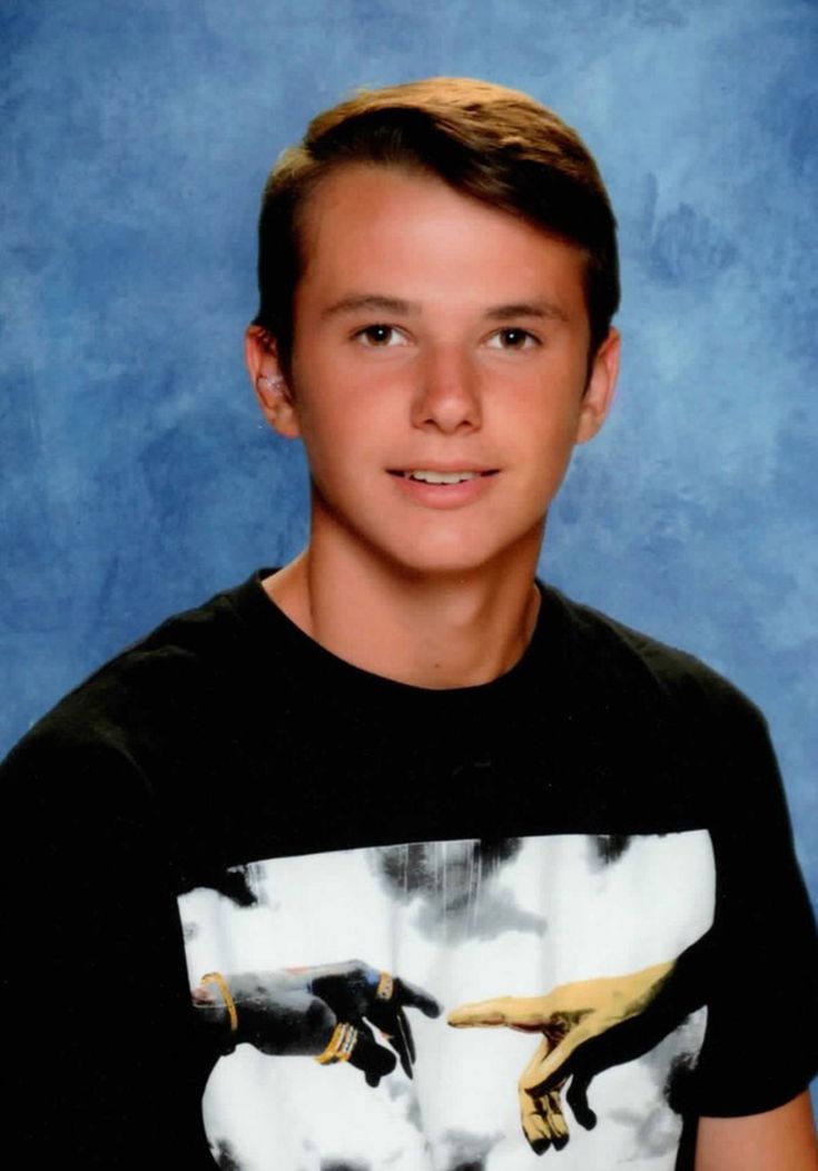 a young boy is posing for a photo