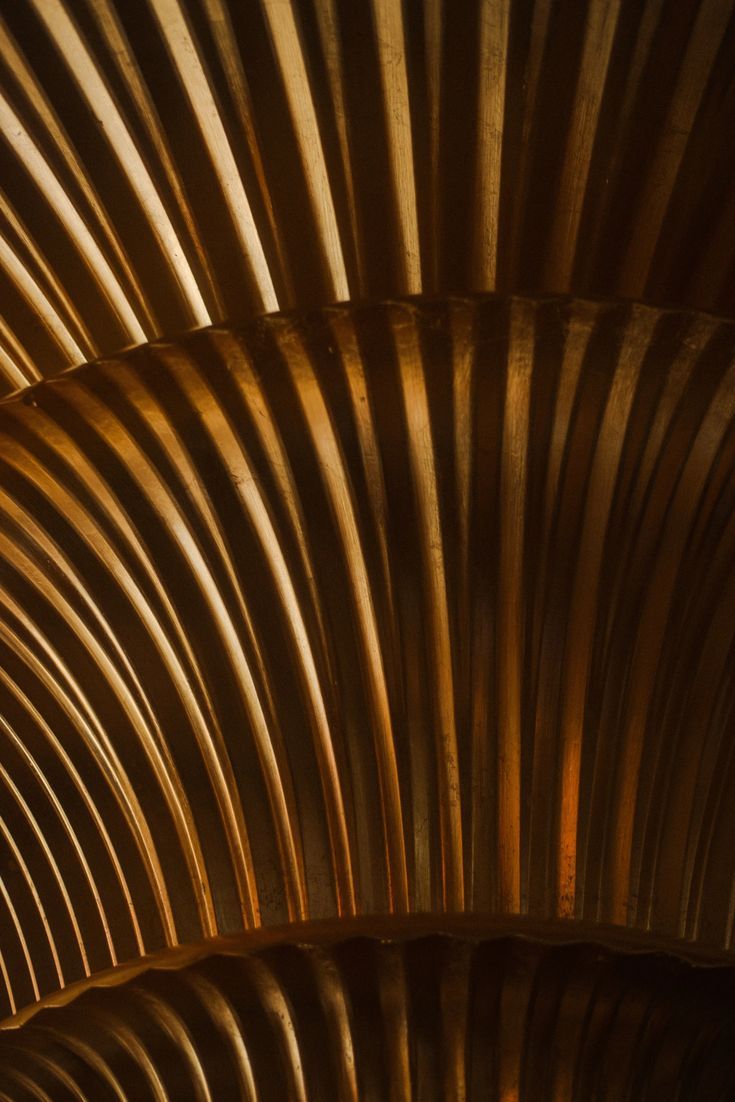 the underside of a metal structure with wavy lines