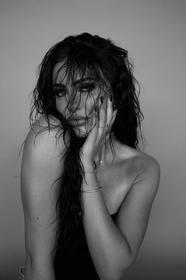 a black and white photo of a woman with wet hair