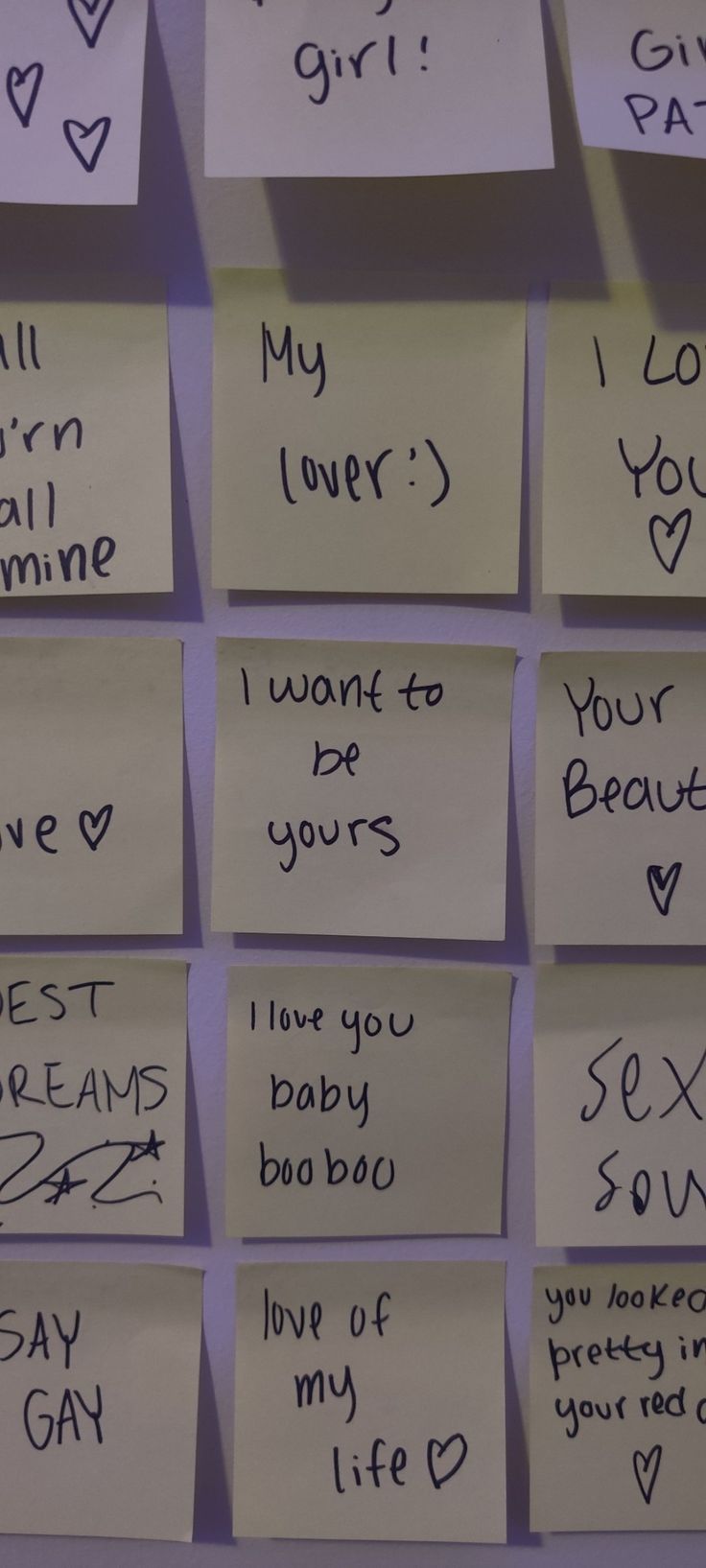 many post it notes are pinned to the wall with writing on them and attached to magnets that say i love you