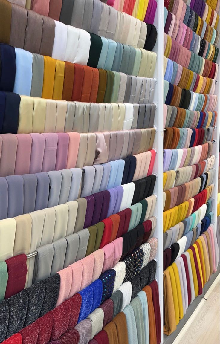 rows of different colored ties on display in a store