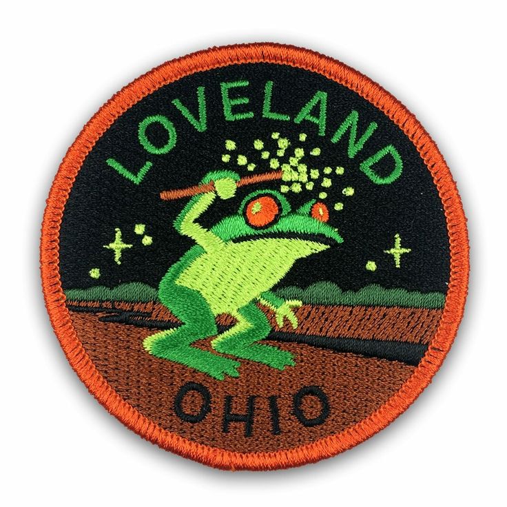 a patch with the words loveland, ohio on it and a frog leaping in the air