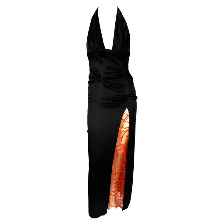 Presenting a stunning black and orange Gianni Versace halterneck gown, designed by Donatella Versace. From the Spring/Summer 1999 collection, this beautiful dress features ruching throughout the torso, a halterneck, an exposed back, and an angular neckline. This full-length gown is made complete with a high slit at the front and an abstract coral-colored mesh underlayer. A rare find, be sure to check out our store front for other vintage Gianni Versace gems. Approximate measurements: Size - IT38 Versace Donatella, Orange Outfit, Versace Couture, Full Length Gowns, Cute Lazy Outfits, Donatella Versace, Lazy Outfits, Black And Orange, Store Front