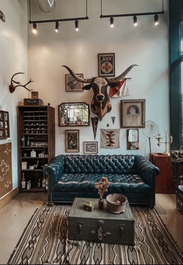 a living room filled with lots of furniture and pictures on the wall above it's couch