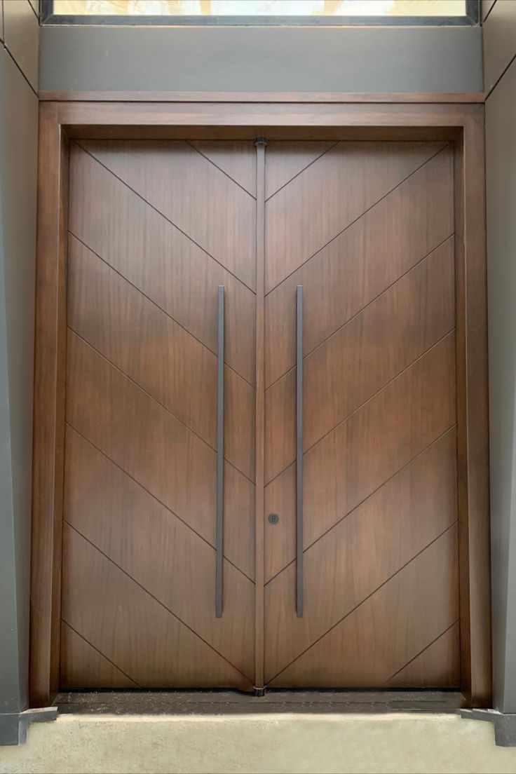 two wooden doors in front of a building