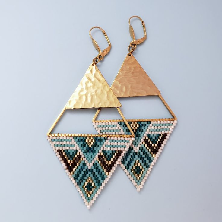 two triangle shaped earrings with gold and blue seed beading on the sides, hanging from brass hooks