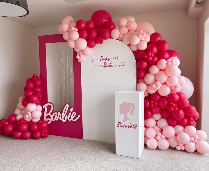 a room decorated with balloons and pinks