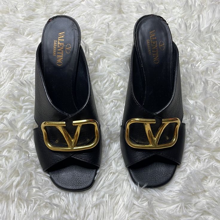 Valentino Vlogo Mules Sandals New Collection, Super Comfortable! Size 35 Worn Less Than 5 Times Flaw Last Pic Calf Leather Open Toe Heels With Gold-tone Hardware, Gold-tone Open Toe Heels In Calf Leather, Gold-tone Open Toe Calf Leather Heels, Black Leather Sandals With Gold-tone Hardware, Luxury Black Mules With Buckle Closure, Leather Open Toe Heels With Gold-tone Hardware, Luxury Leather Heels With Logo, Chic Open Toe Sandals With Logo, Leather Open Toe Sandals With Logo