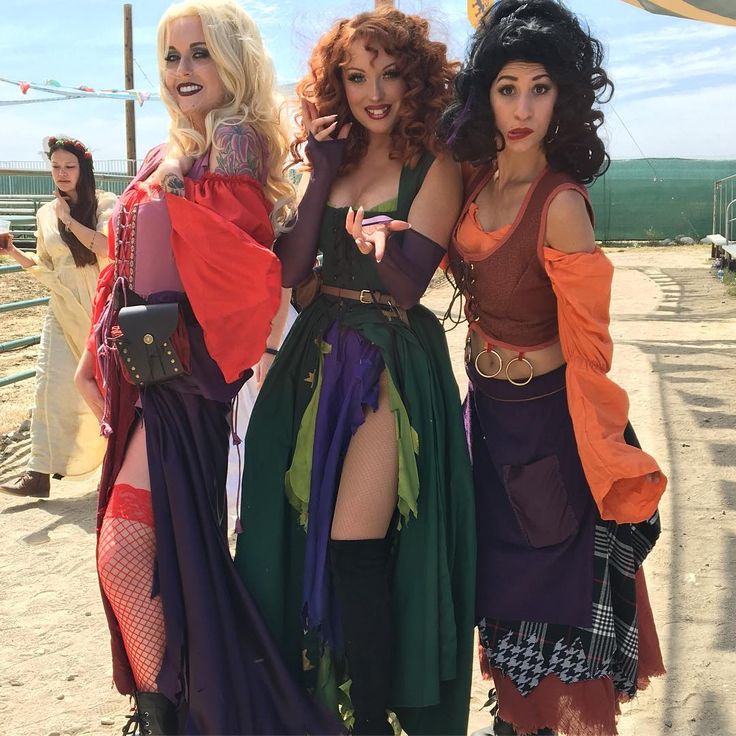 three women dressed in costumes posing for the camera