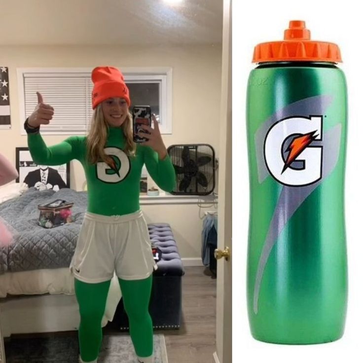 a woman in green and white outfit standing next to a bottle with the letter g on it