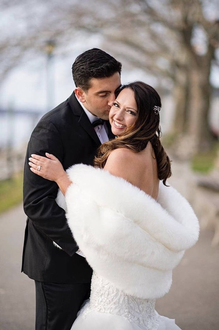 a bride and groom posing for a wedding photo