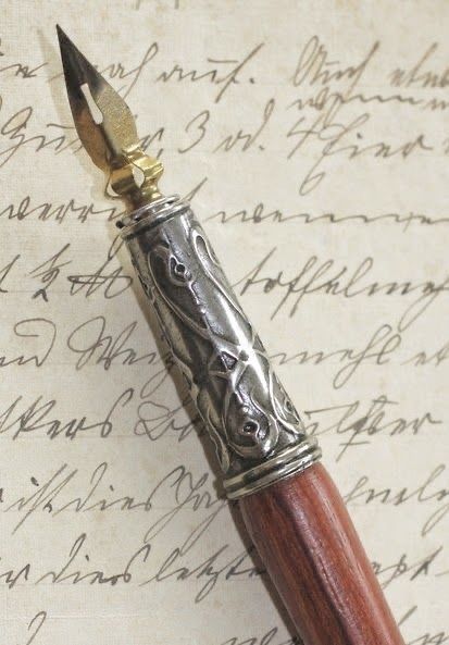 a fountain pen sitting on top of an old manuscript