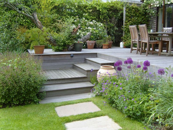 a garden with steps leading up to the deck