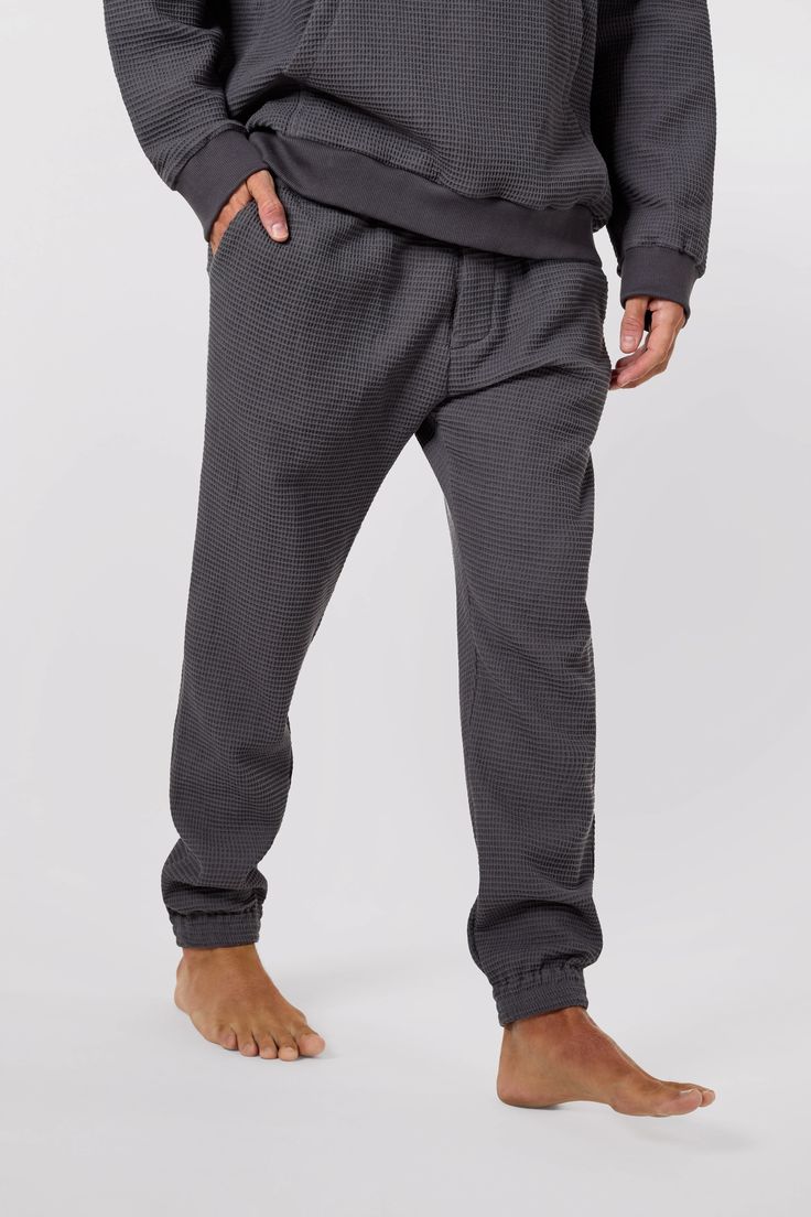 Elevate your loungewear game with the unisex Jet Set Jogger Pants from Afterlight Leisure. Made from 100% cotton waffle knit fabric, these stylish pants also feature terry cloth lining in the front and back pockets for added comfort. Each detail is thoughtfully-curated from the silver logo-embossed drawstring cord to the seashell button enclosed front placket and back pocket. Perfect for airplane loungewear or just relaxing at home, these joggers are a must-have for anyone who prioritises comfor Stylish Pants, Silver Logo, Just Relax, Private Jet, Terry Cloth, Waffle Knit, Jet Set, Aspen, Jogger Pants