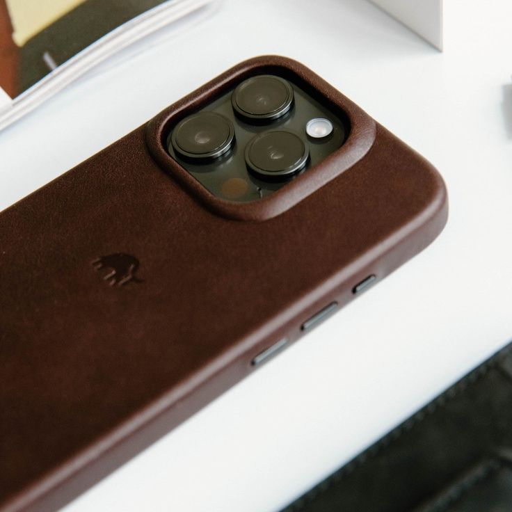 an iphone case sitting on top of a white table