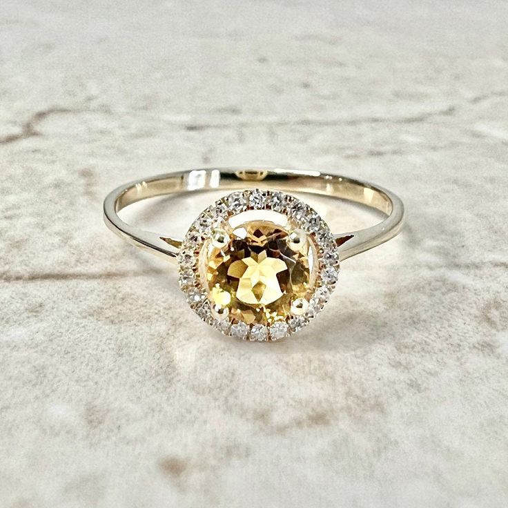 14K Round Citrine Halo Ring - Yellow Gold Citrine Ring - Gemstone Halo Ring - Citrine Promise Ring - November Birthstone Gift -Birthday Gift Beautiful 14 karat yellow gold citrine & diamond halo ring featuring a natural round citrine, the birthstone for November!  The gemstone weighs approximately 1/2 carat, and is haloed by 22 diamond weighing approximately 0.07 carat. G-H SI. Size 7 US. Halo width: 8.23 mm.  > Resizing not included.  This ring can be resized to fit most fingers.  Please contac Citrine Promise Ring, Citrine Halo Ring, November Birthstone Ring, Diamond Halo Ring, Citrine Ring, November Birthstone, Halo Diamond Ring, Ring Gemstone, Halo Ring