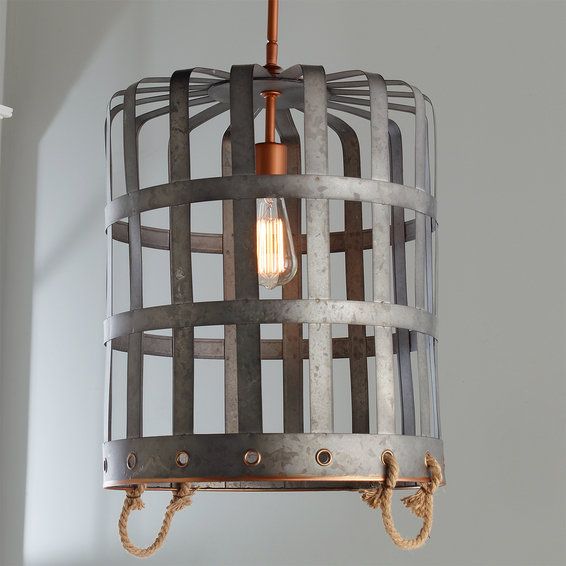 a light fixture made out of metal and rope hanging from the ceiling in a room