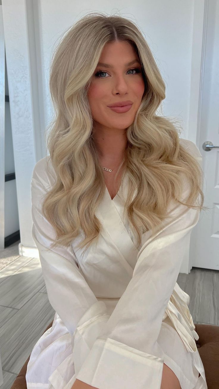 a woman with long blonde hair sitting on a couch