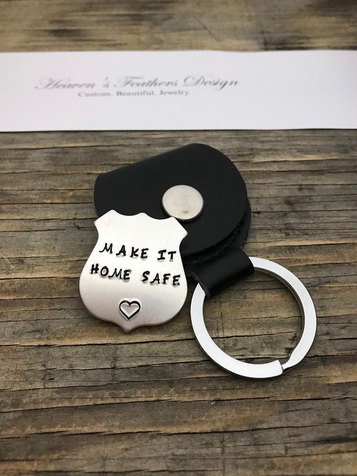 a keychain that says make it home safe with a police badge on it