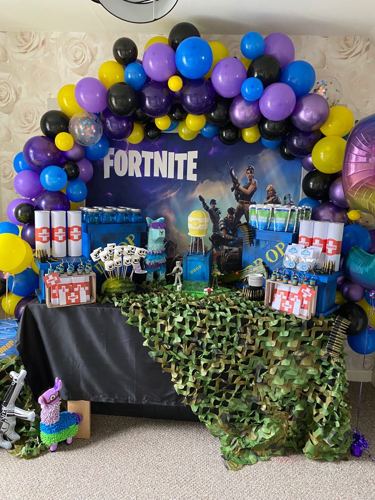 a fortnite themed birthday party with balloons and decorations