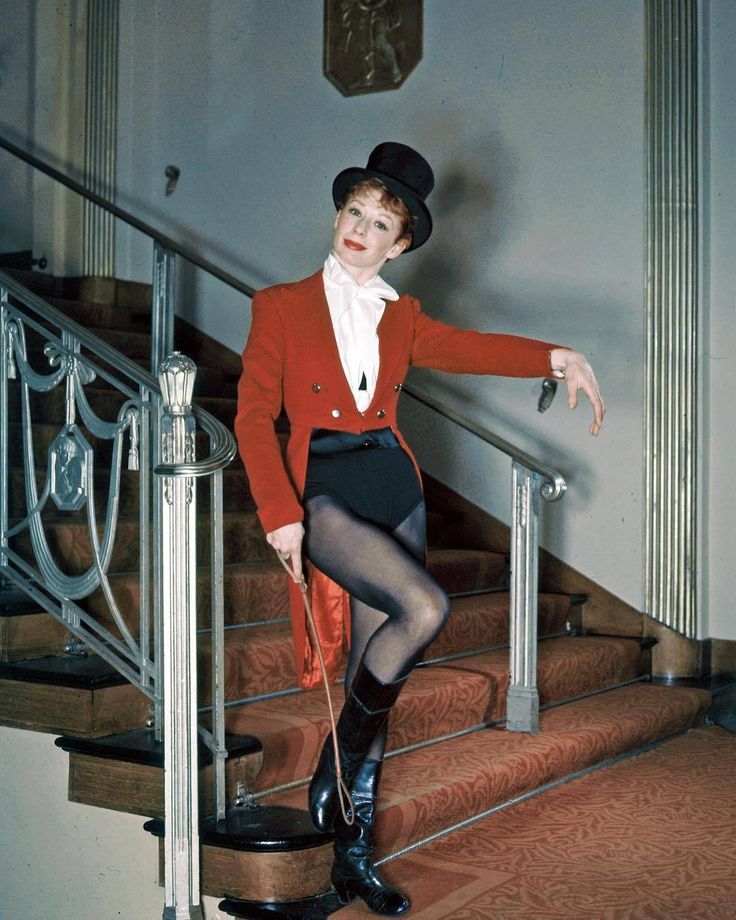 a woman in tights and boots standing on some stairs