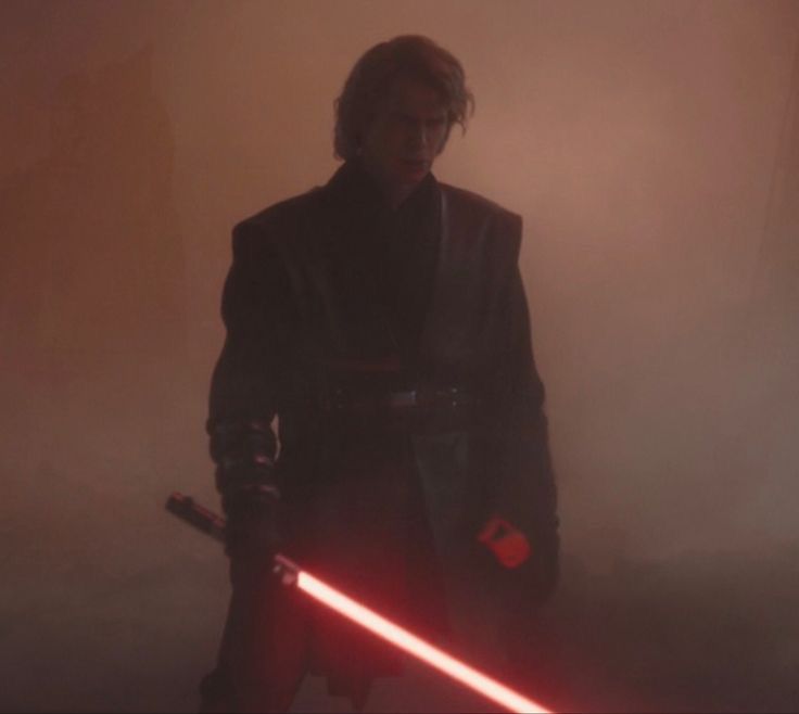 a man with a lightsaben standing next to a red light saber in the dark