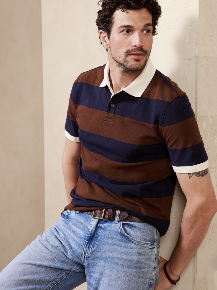 A classic polo with bold stripes and embroidered BR logo, this style staple is crafted from sumptuous, certified-organic cotton to add a little softness wherever your day leads.  ORGANIC: Made with certified, organically grown cotton that's easier on Brown Cotton Polo Shirt With Polo Collar, Brown Cotton Polo Shirt, Classic Striped Polo Shirt, Cotton Polo Shirt With Horizontal Stripes, Classic Brown Tops With Striped Collar, Fitted Brown Cotton Polo Shirt, Classic Striped Relaxed Fit Polo Shirt, Striped Cotton Polo Shirt With Ribbed Collar, Cotton Polo Shirt With Signature Stripes