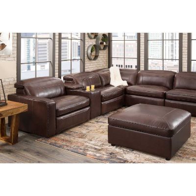 a living room filled with brown leather furniture