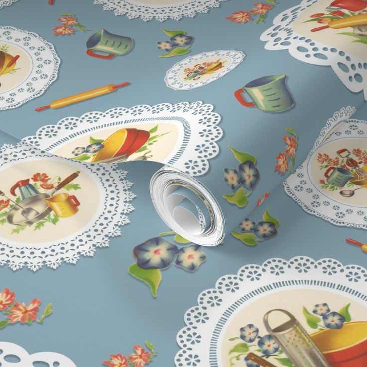 the table cloth is yellow with white doily and floral designs on it, along with an assortment of utensils