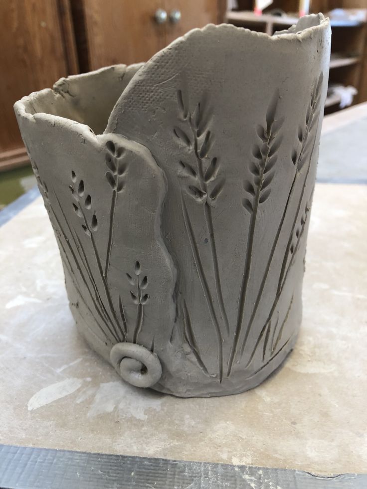 a gray vase sitting on top of a table