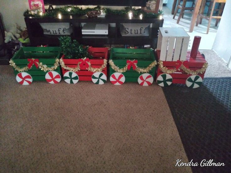 a christmas train with candy canes on the front and sides, sitting in front of a fireplace