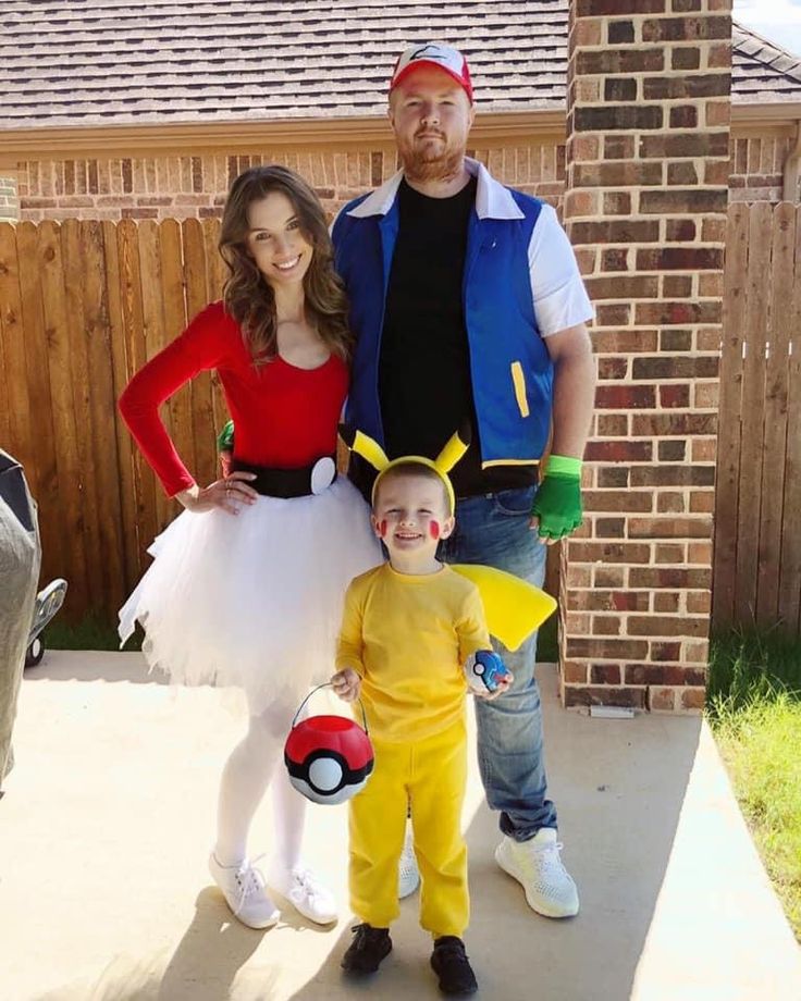 a man, woman and child dressed up in pokemon costumes standing on a porch with their arms around each other