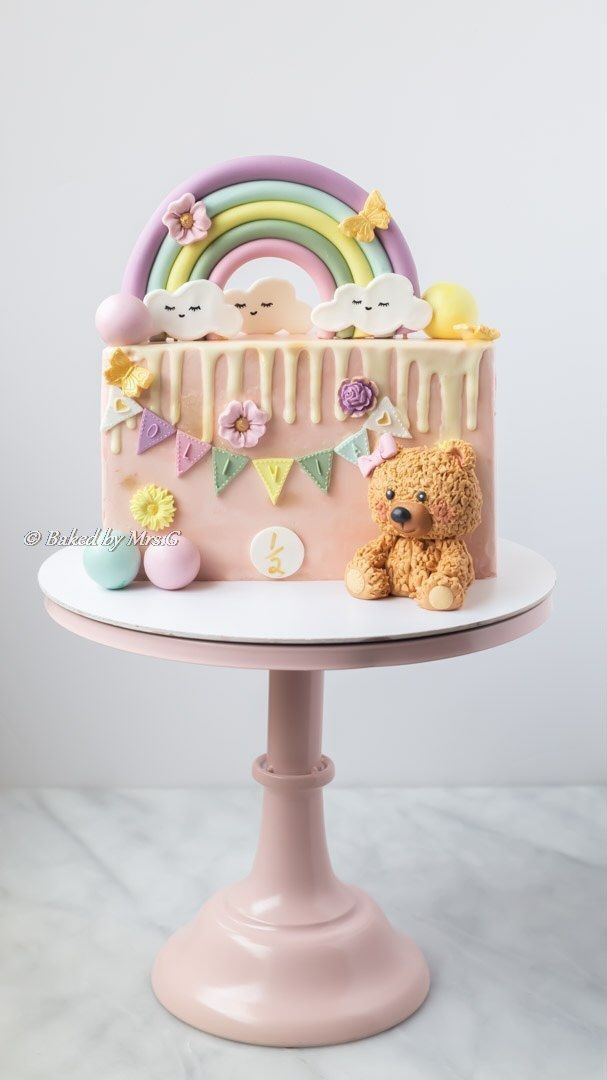 there is a cake with icing on it and a teddy bear next to it