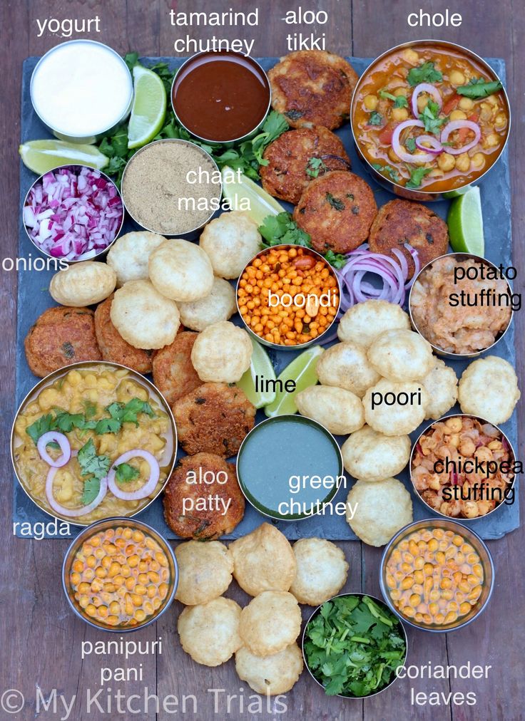 an assortment of different foods are displayed on a table with the names in each bowl