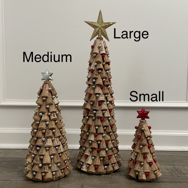 three small wooden christmas trees made out of wine corks