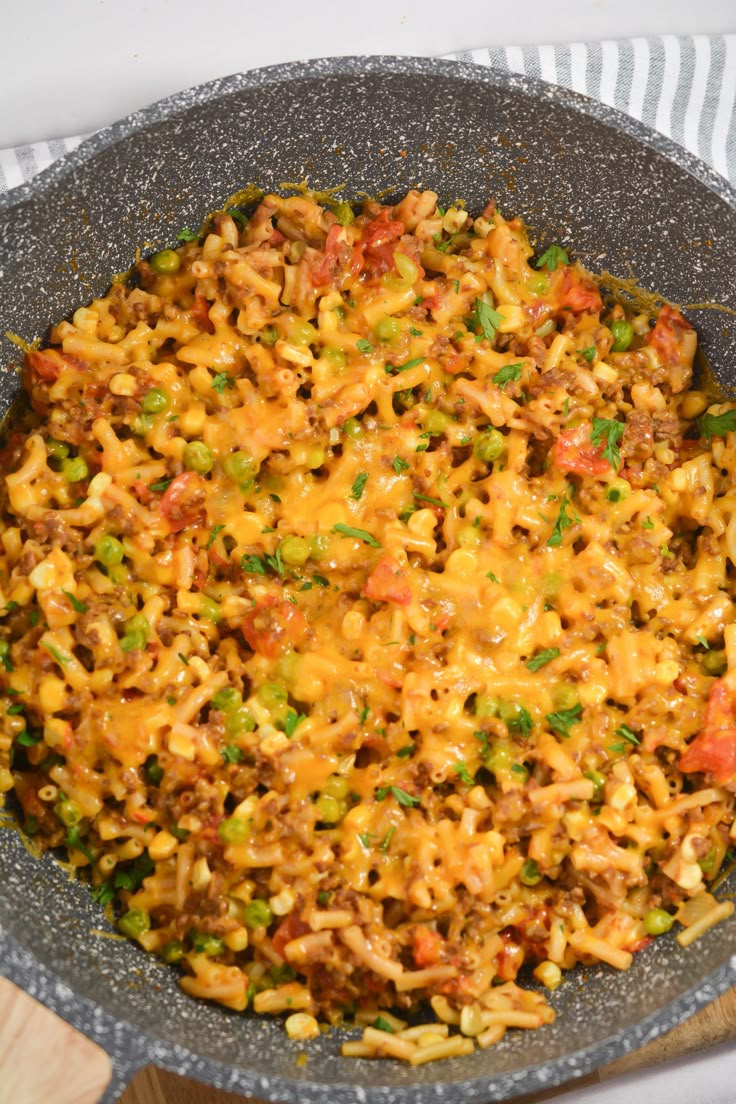 a bowl filled with rice and vegetables on top of a table