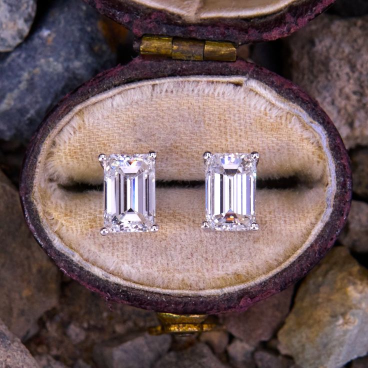 This lovely pair of emerald cut diamond stud earrings each feature one (1) emerald cut diamond set into a four-prong setting. The earrings are finished with friction backs and posts for pierced ears. Classic Emerald Cut Baguette Diamond Jewelry, Fine Jewelry Earrings With Baguette Diamonds In Emerald Cut, Emerald Cut Baguette Diamond Anniversary Earrings, Emerald Cut Baguette Diamond Earrings For Anniversary, Emerald Cut Baguette Diamond Earrings, Wedding Earrings With Baguette Diamonds In Emerald Cut, Wedding Earrings With Emerald Cut Baguette Diamonds, Baguette Diamond Earrings With Emerald Cut For Wedding, Classic Diamond Earrings With Baguette Diamonds