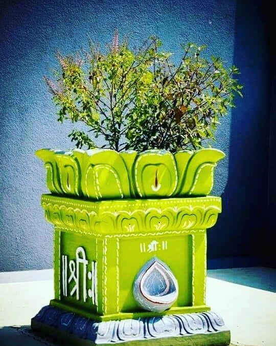 a green planter sitting on top of a table