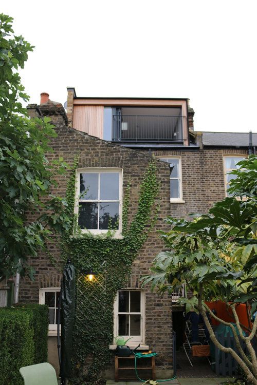 an old brick building with ivy growing on it