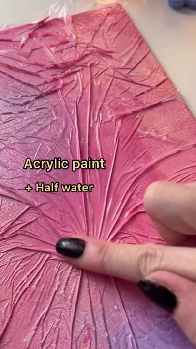 someone is using acrylic paint to create a flower design on a piece of paper