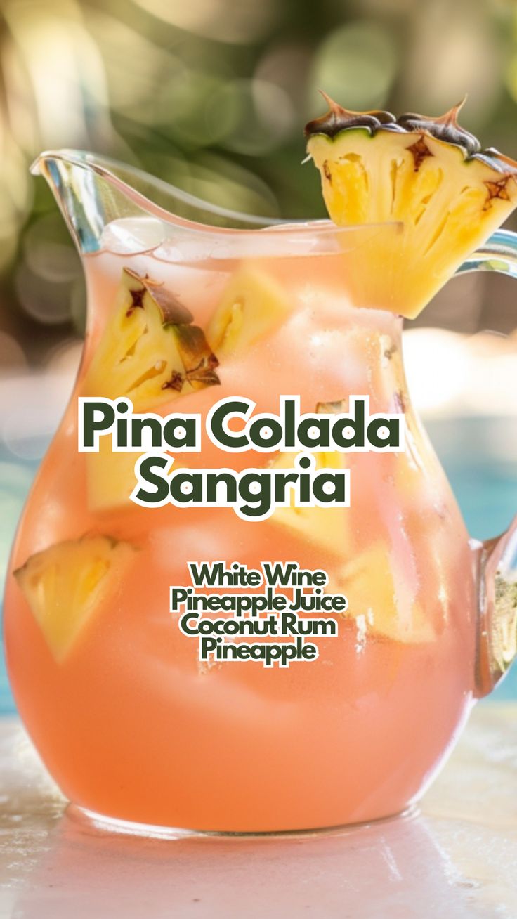 a pitcher filled with pineapple sangria sitting on top of a table