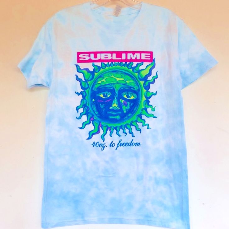 a blue t - shirt with the words sublime on it, and an image of a sun