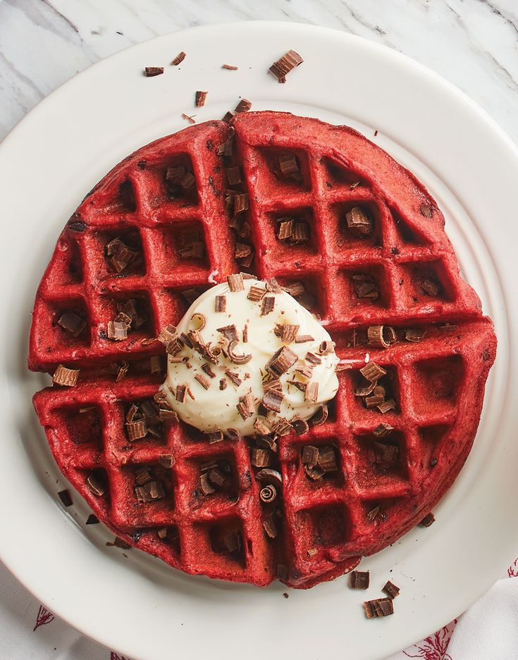 a waffle topped with whipped cream and chocolate chips