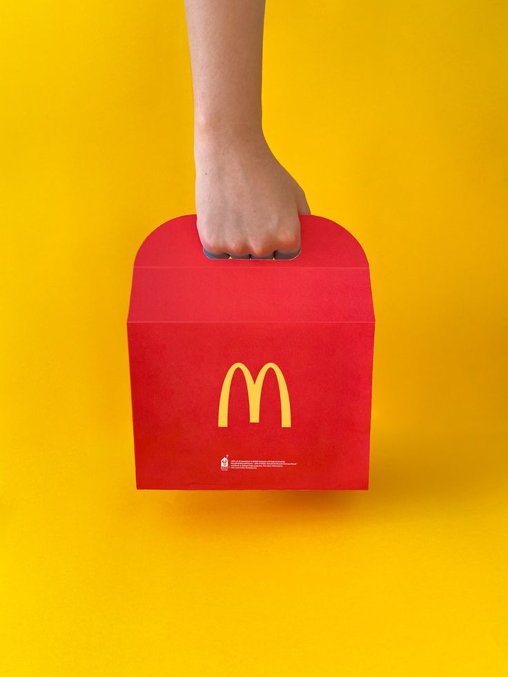 a foot on top of a mcdonald's box