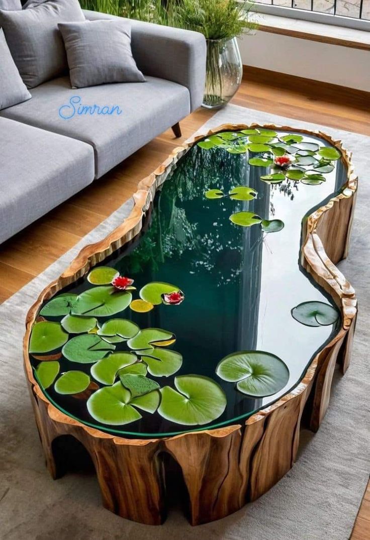 a coffee table made out of wood and glass with water lilies on the top