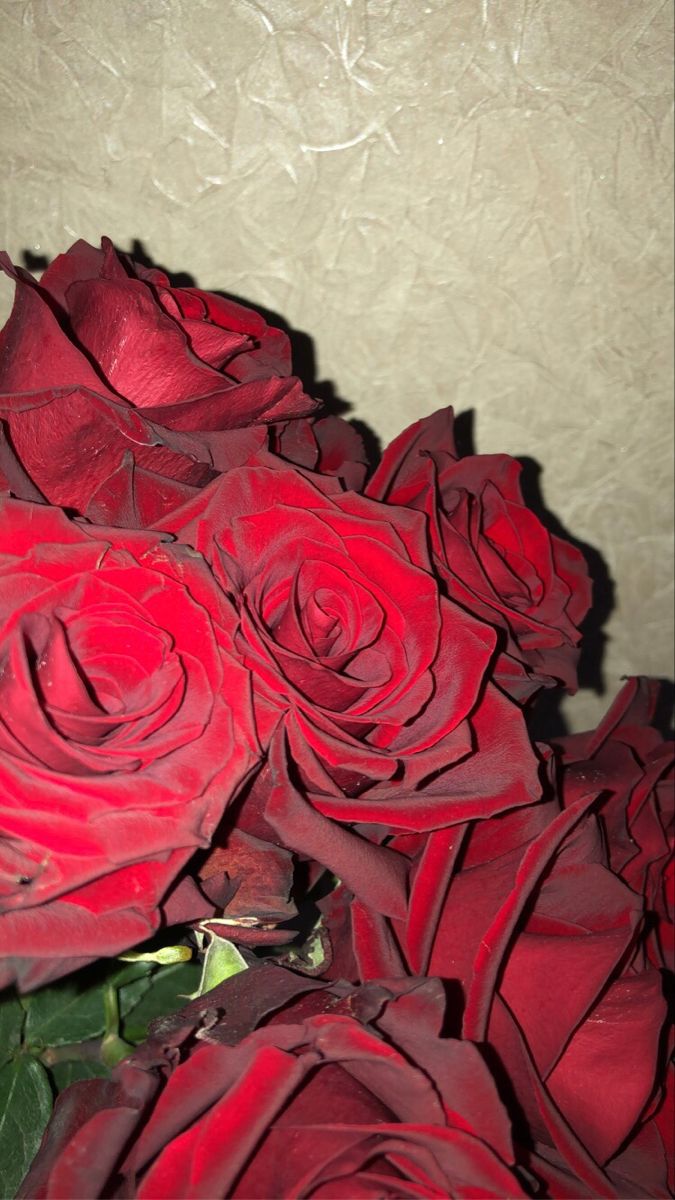 a bouquet of red roses sitting on top of a table