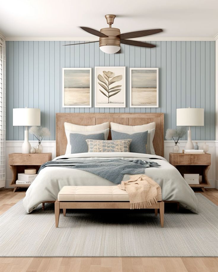 a bedroom with blue and white walls, wood floors and a bed in the middle